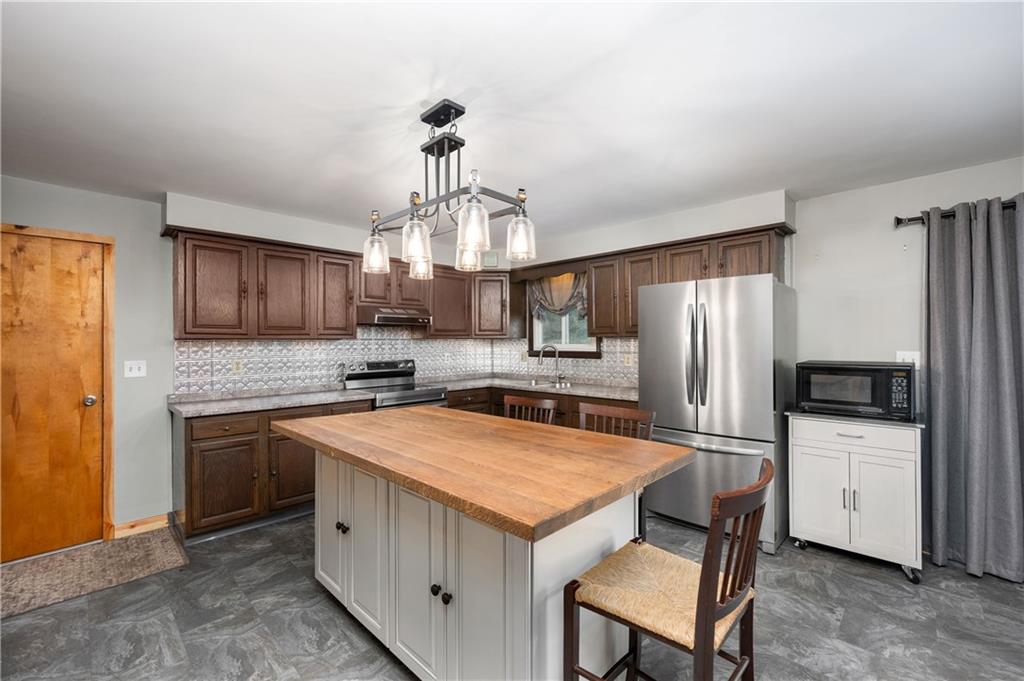 222 Dick Road Prospect, PA 16052 - Photo 10 of 29 a kitchen with stainless steel appliances a sink stove and refrigerator