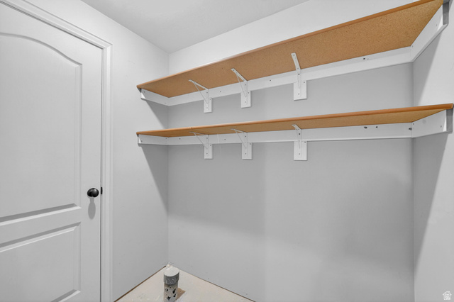 14771 Haddington Road Draper, UT 84020 - Photo 31 of 44 Corner shelving unit featuring two levels of wood-finish shelving with white brackets