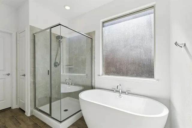 a bathroom with a bathtub and a shower