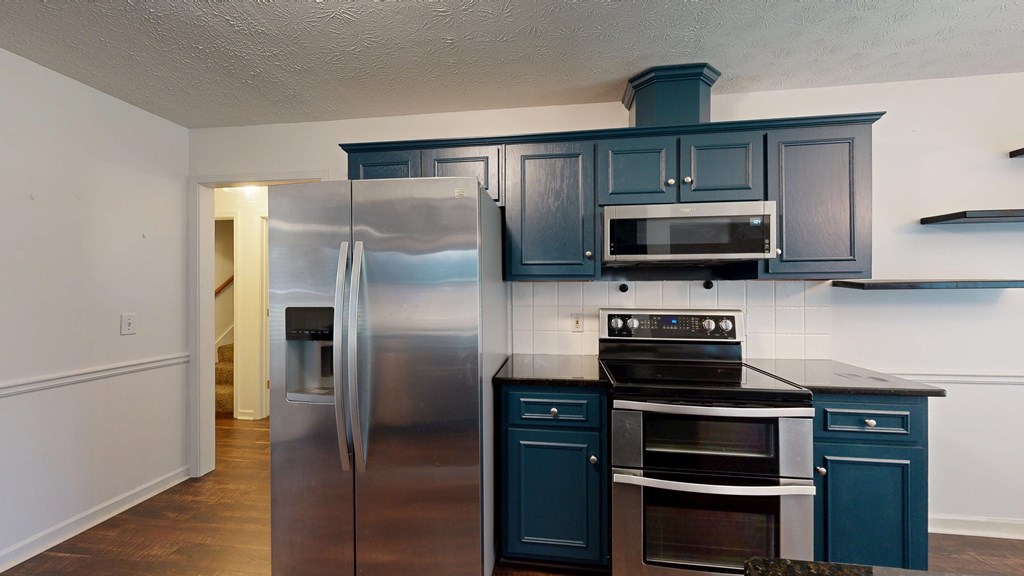 1278 Jones Road Cataula, GA 31804 - Photo 17 of 94 a kitchen with stainless steel appliances and wooden cabinets