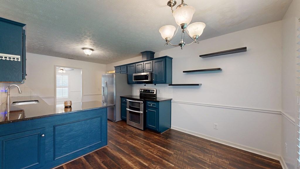 1278 Jones Road Cataula, GA 31804 - Photo 18 of 94 a kitchen with wooden floor and stainless steel appliances