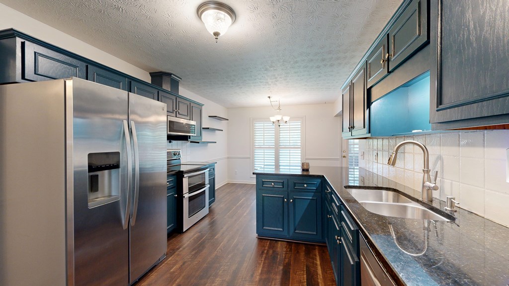 1278 Jones Road Cataula, GA 31804 - Photo 19 of 94 a kitchen with stainless steel appliances granite countertop a refrigerator a sink a stove and oven