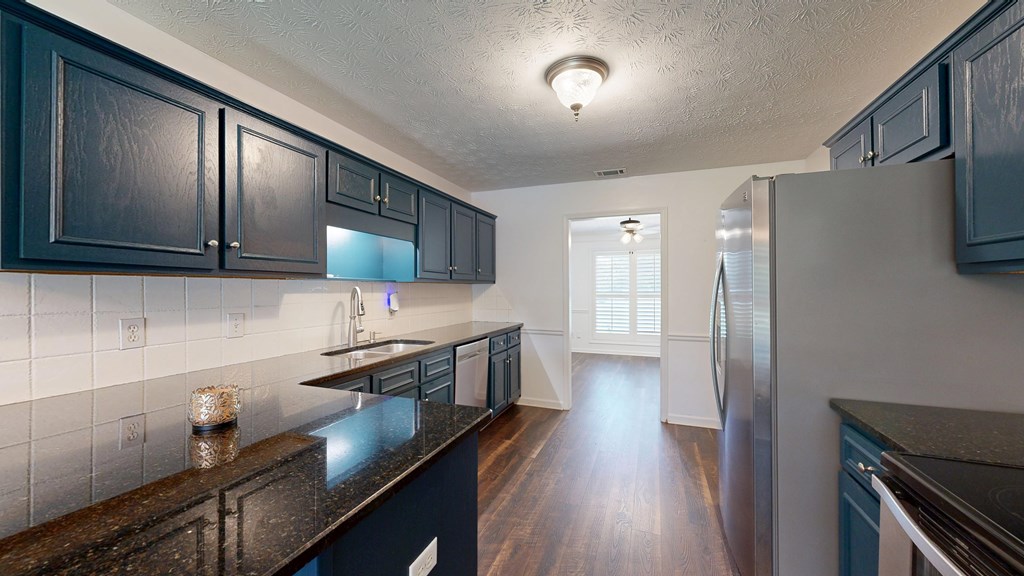 1278 Jones Road Cataula, GA 31804 - Photo 20 of 94 a kitchen with stainless steel appliances granite countertop a sink stove and refrigerator