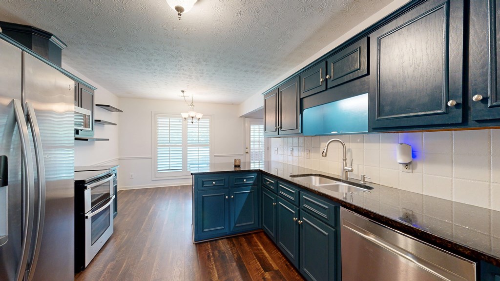 1278 Jones Road Cataula, GA 31804 - Photo 23 of 94 a kitchen with granite countertop a sink stainless steel appliances and cabinets