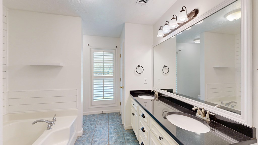 1278 Jones Road Cataula, GA 31804 - Photo 31 of 94 a spacious bathroom with a granite countertop double vanity sink a mirror and a bathtub