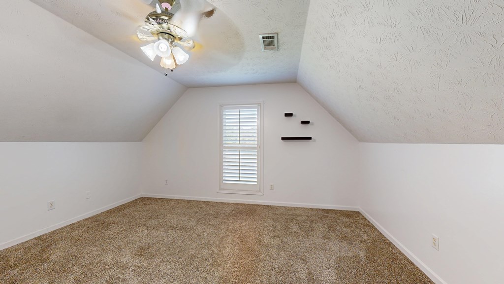 1278 Jones Road Cataula, GA 31804 - Photo 39 of 94 an empty room with a chandelier fan and windows