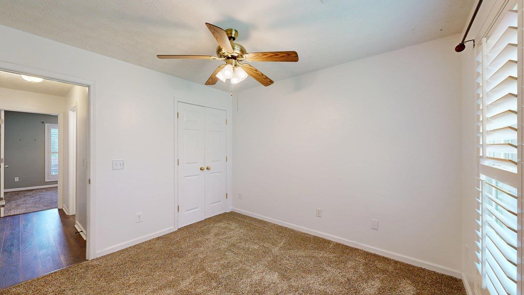 1278 Jones Road Cataula, GA 31804 - Photo 44 of 94 an empty room with wooden floor fan and windows