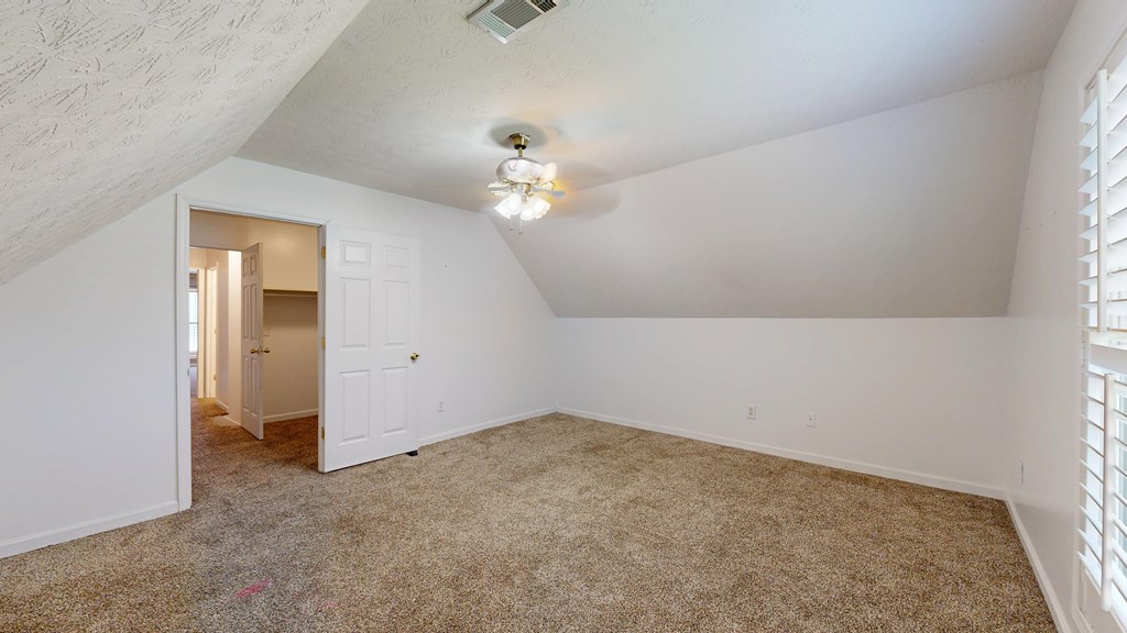 1278 Jones Road Cataula, GA 31804 - Photo 71 of 94 an empty room with a chandelier fan and a window
