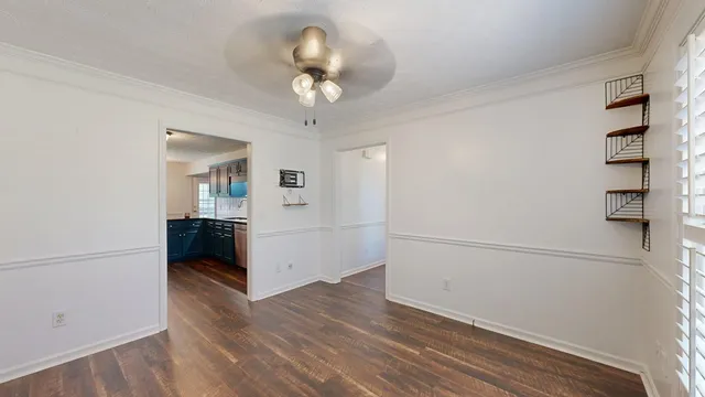 a view of a livingroom with wooden floor and a fireplace