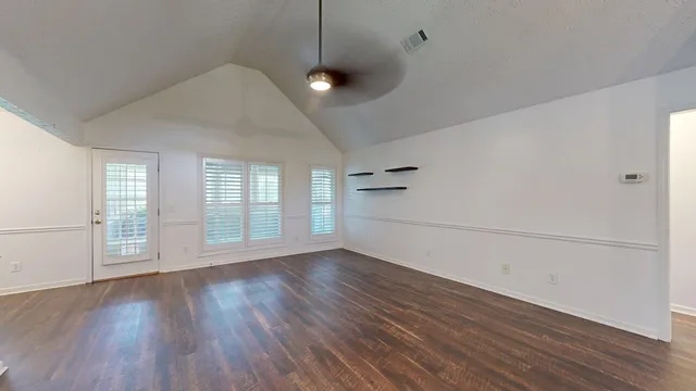 a kitchen with wooden floor and stainless steel appliances