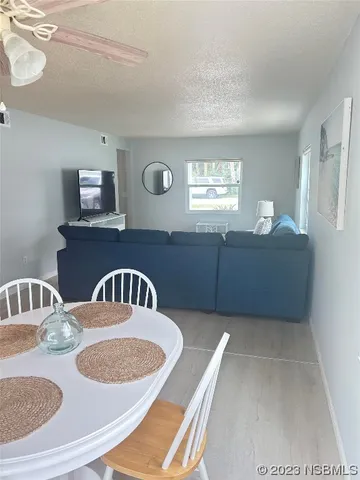 a kitchen with a sink a stove a dining table and chairs