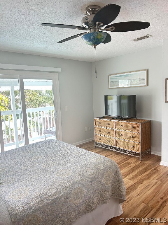 910 Maple Street, Unit A New Smyrna Beach, FL 32169 - Photo 15 of 18 a bedroom with a large bed and a chandelier fan