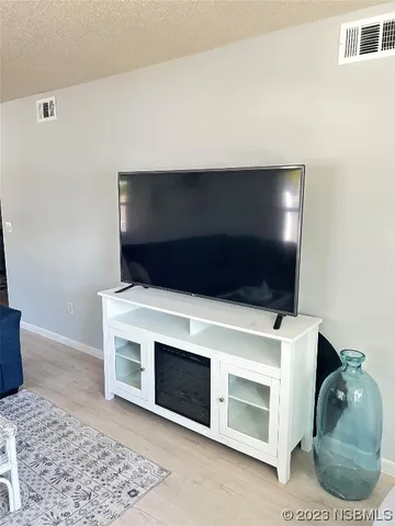 a living room with a fireplace and a rug