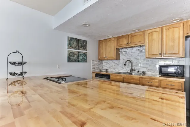 a kitchen with granite countertop a stove a sink and a window