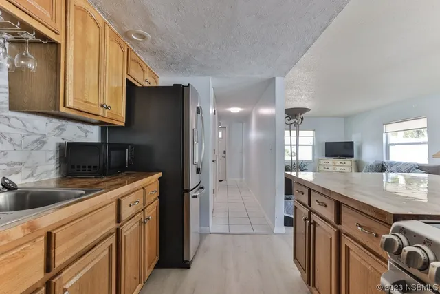 a kitchen with a sink stove and refrigerator