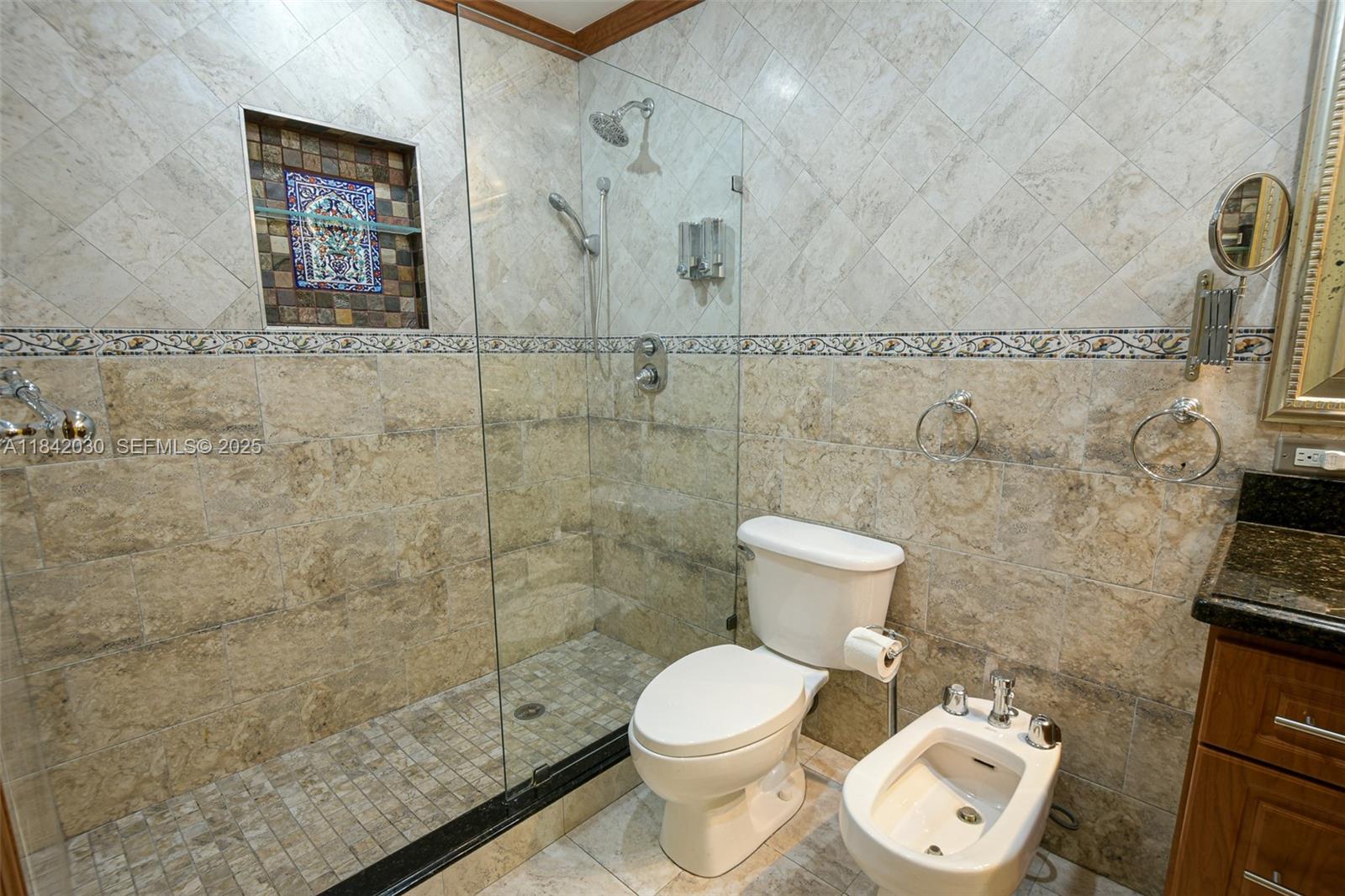 3542 Southwest 17th Street, Unit 2B Miami, FL 33145 - Photo 17 of 25 a white toilet sitting next to a bathroom sink