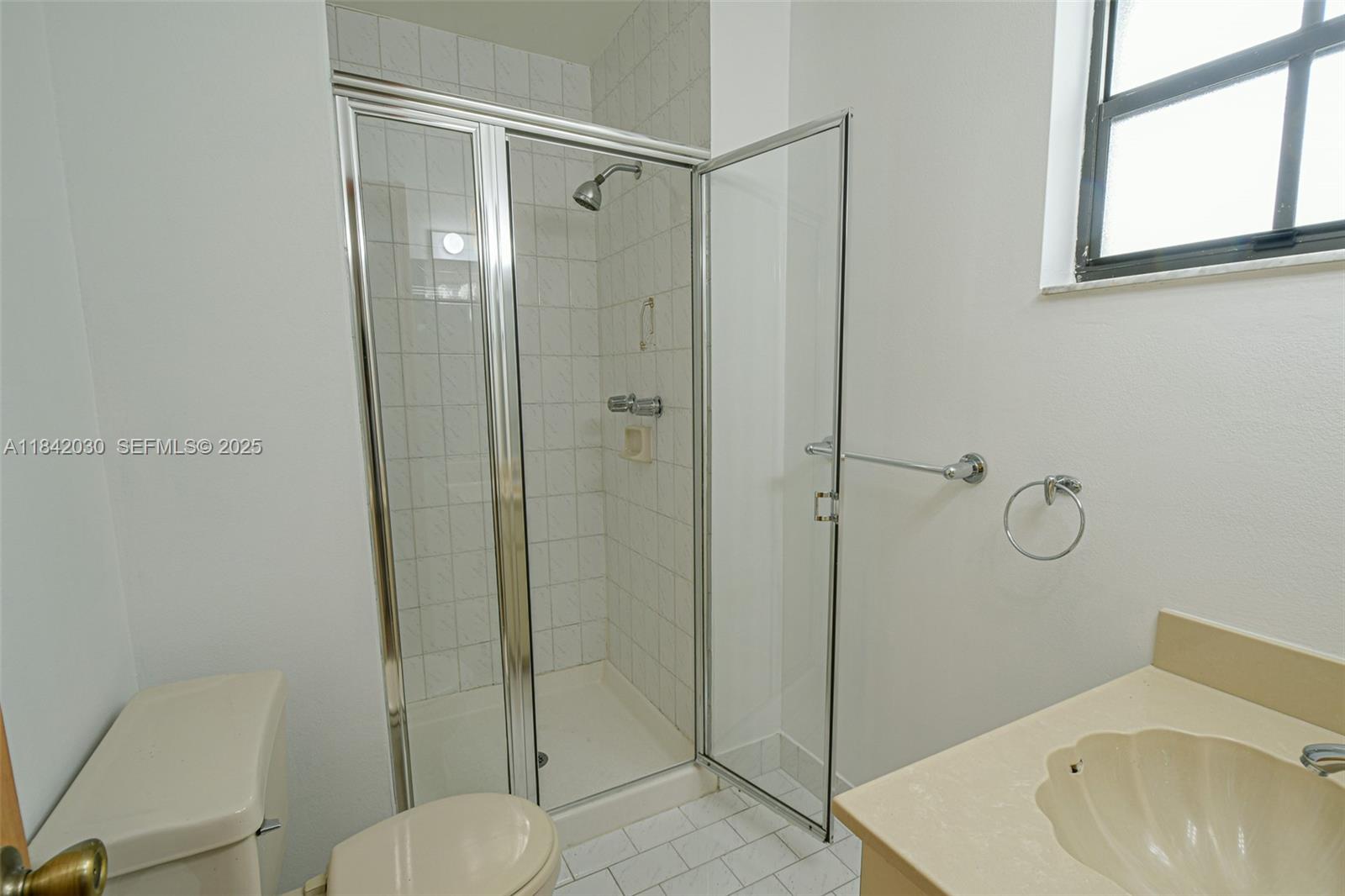 3542 Southwest 17th Street, Unit 2B Miami, FL 33145 - Photo 23 of 25 a bathroom with a shower a sink and toilet