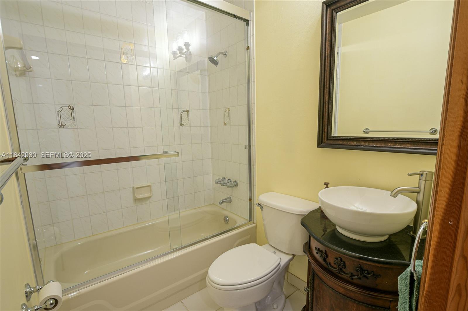 3542 Southwest 17th Street, Unit 2B Miami, FL 33145 - Photo 6 of 25 a bathroom with a sink a toilet and shower