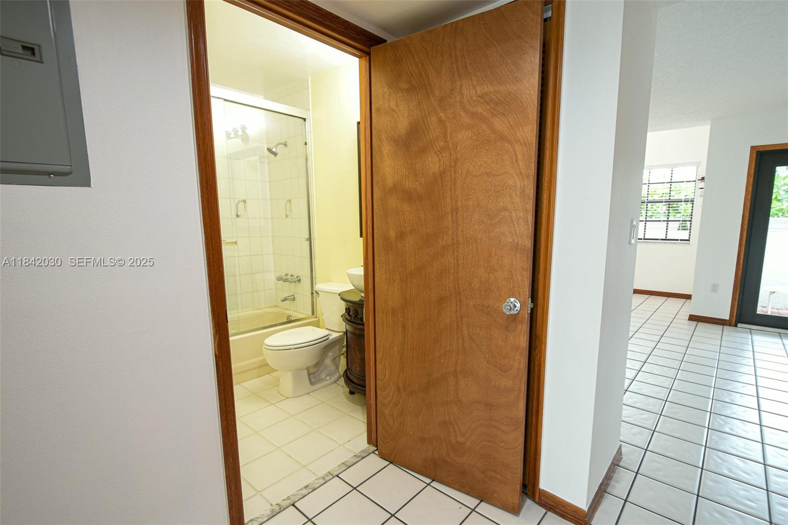 3542 Southwest 17th Street, Unit 2B Miami, FL 33145 - Photo 7 of 25 a bathroom with a granite countertop toilet and a shower