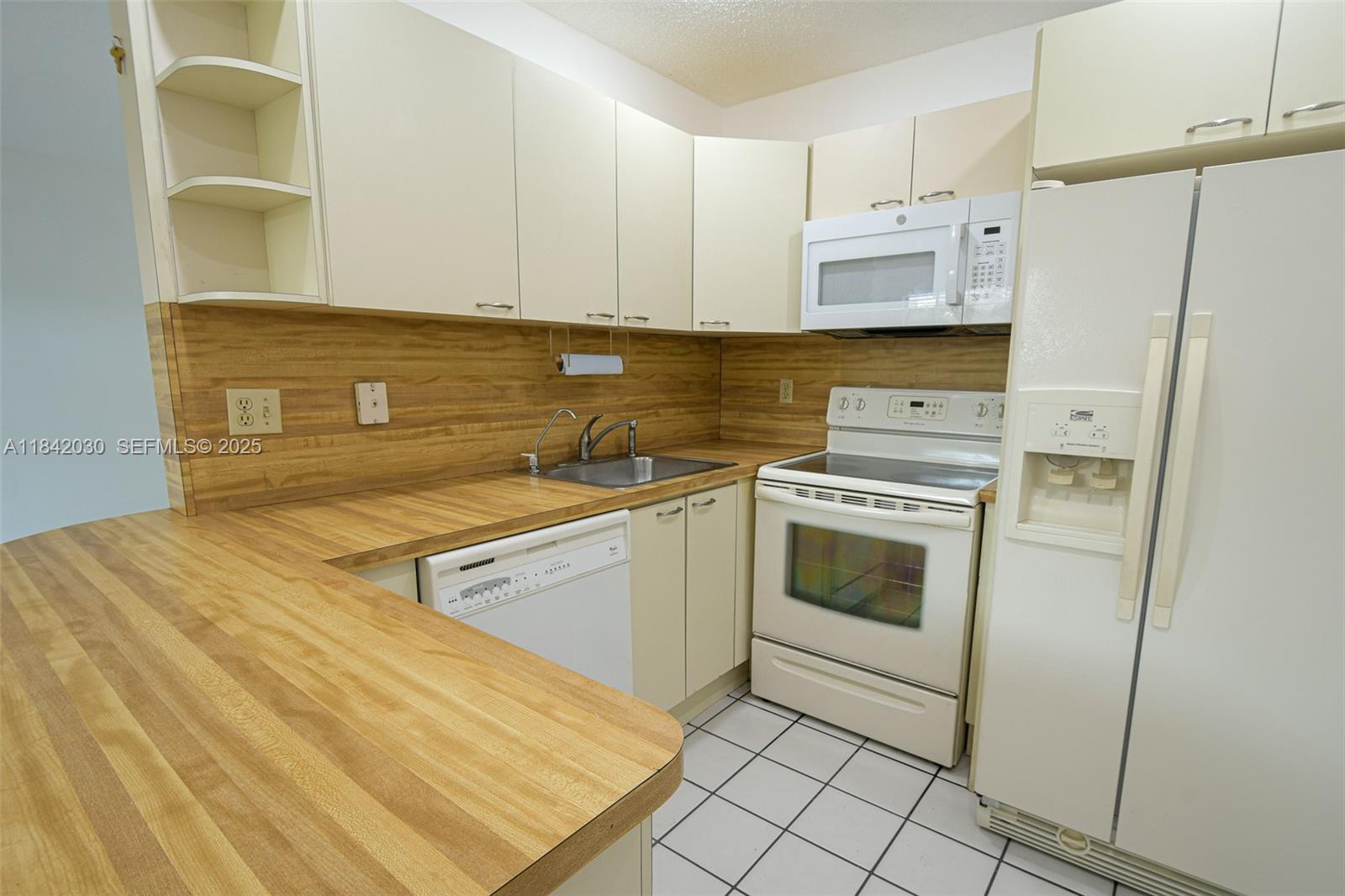 3542 Southwest 17th Street, Unit 2B Miami, FL 33145 - Photo 10 of 25 a view of a kitchen with white cabinets and white appliances
