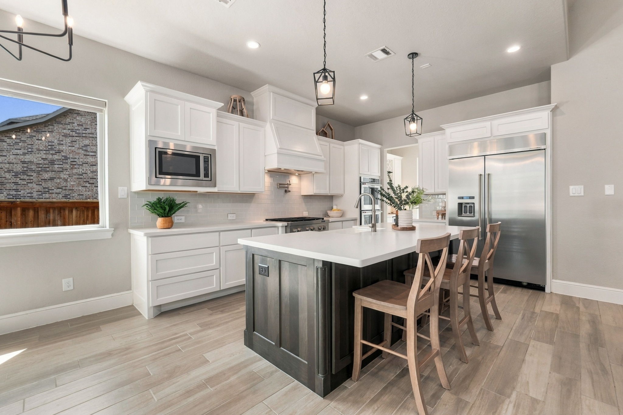 26910 Selinsgrove Road Magnolia, TX 77354 - Photo 16 of 47 Bright cabinetry and quartz countertops create a crisp, timeless kitchen with plenty of workspace.
