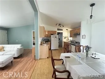 a living room with kitchen island furniture and a kitchen view