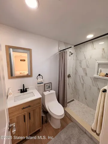 a bathroom with a toilet a sink and a mirror
