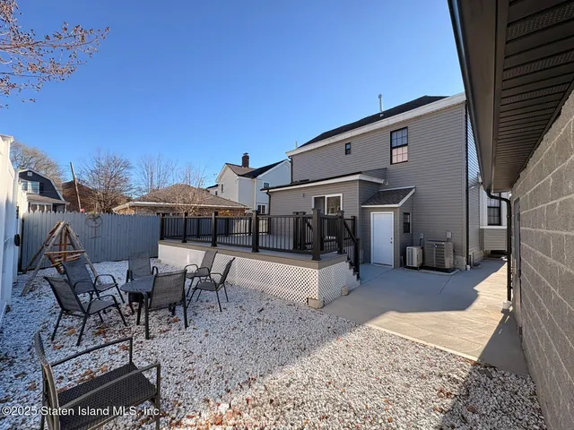 a view of a patio with table and chairs floor to ceiling window with outdoor seating
