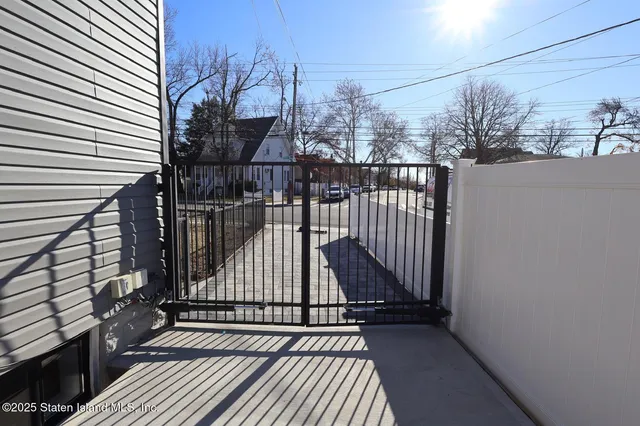 a view of a balcony with wooden floor and fence
