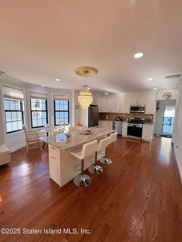 a living room with lots of furniture and kitchen view