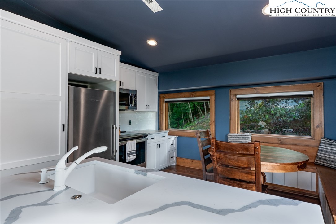550 Pepperroot Road Boone, NC 28607 - Photo 26 of 50 a bathroom with a tub sink and large window