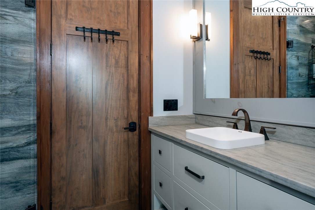 550 Pepperroot Road Boone, NC 28607 - Photo 38 of 50 a bathroom with a granite countertop sink and a mirror