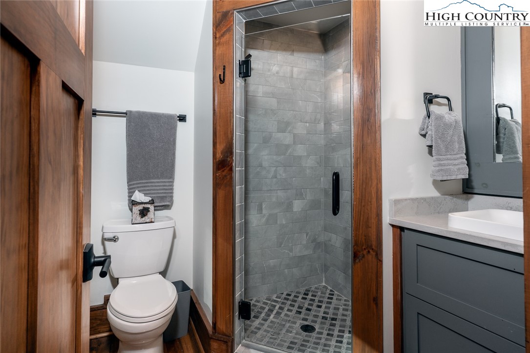 550 Pepperroot Road Boone, NC 28607 - Photo 39 of 50 a bathroom with a granite countertop toilet a sink and shower