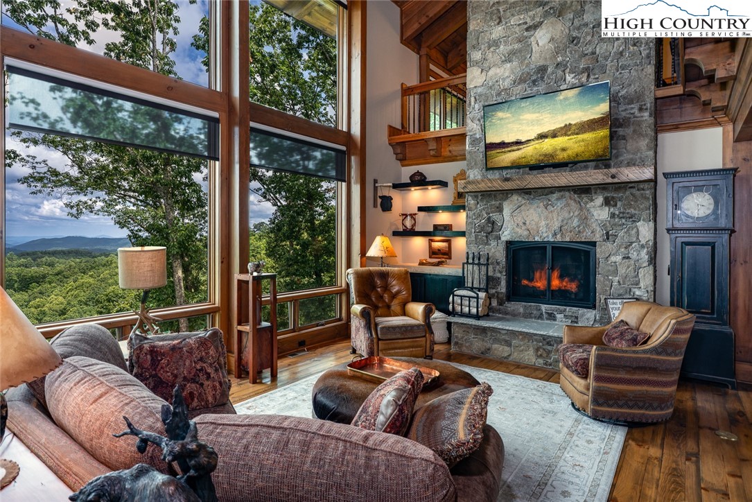 550 Pepperroot Road Boone, NC 28607 - Photo 4 of 50 a outdoor living space with furniture a fireplace and a floor to ceiling window