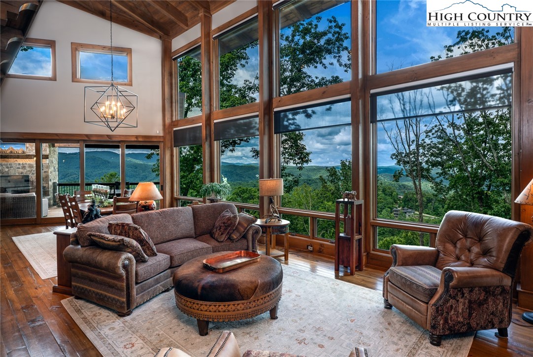 550 Pepperroot Road Boone, NC 28607 - Photo 5 of 50 a living room with furniture a floor to ceiling window and a table