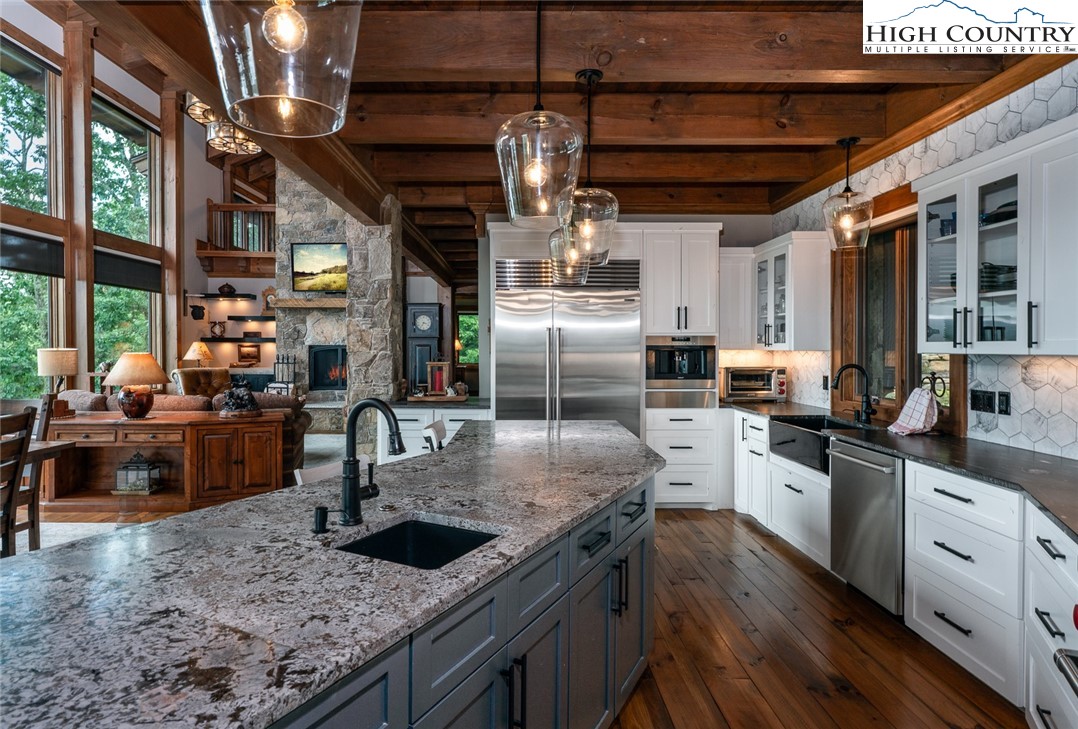 550 Pepperroot Road Boone, NC 28607 - Photo 9 of 50 a kitchen with stainless steel appliances granite countertop a sink window and cabinets