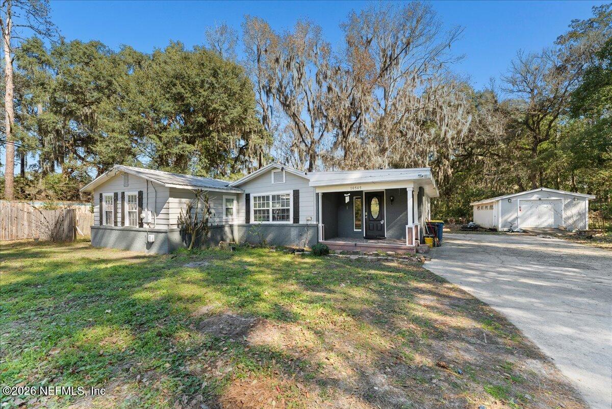 a view of house with outdoor space and swimming pool