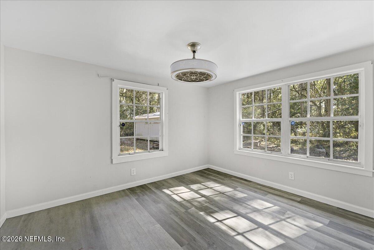 10565 Bessent Road North Jacksonville, FL 32218 - Photo 14 of 27 an empty room with wooden floor and windows