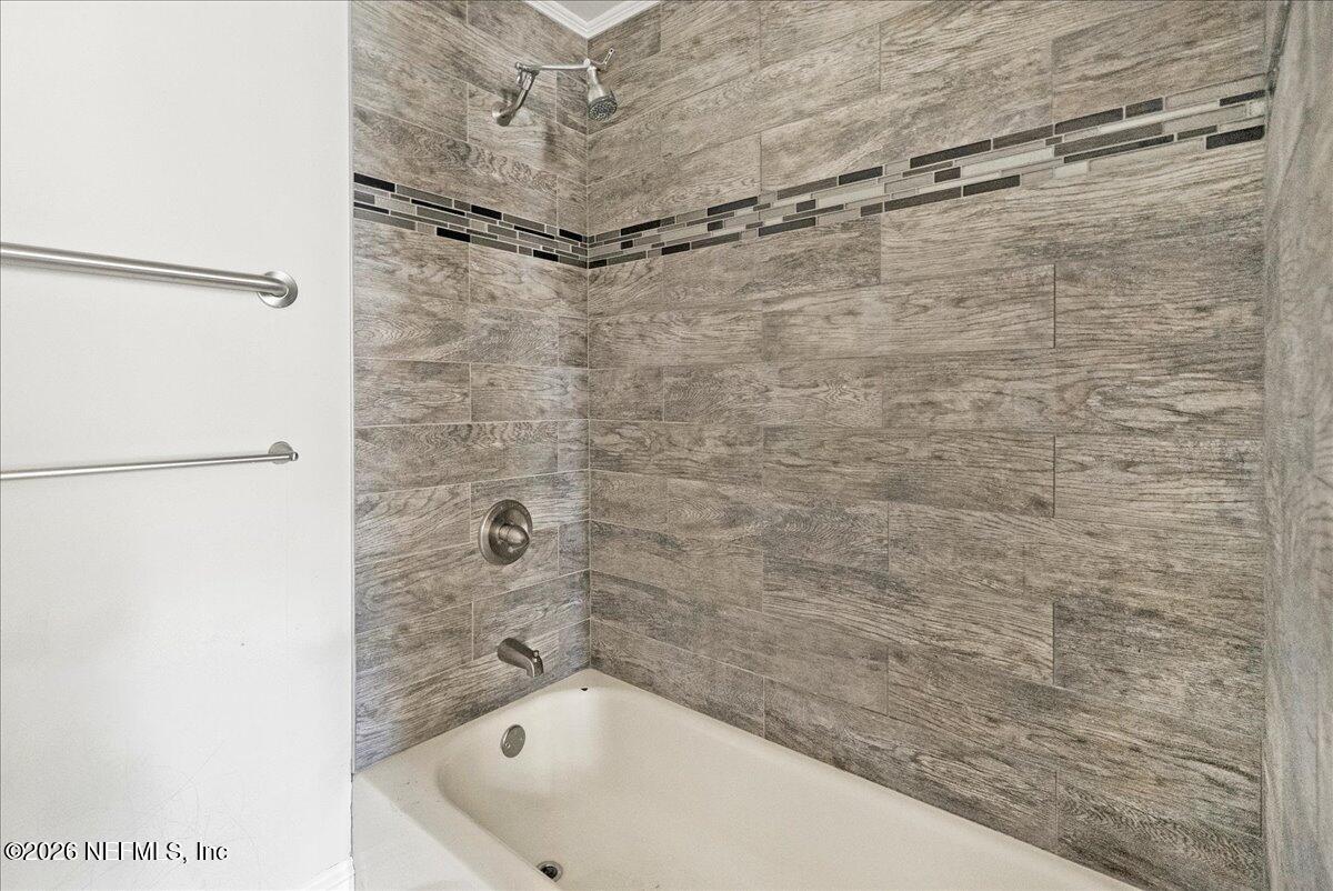 10565 Bessent Road North Jacksonville, FL 32218 - Photo 19 of 27 a bathroom with a bathtub and shower