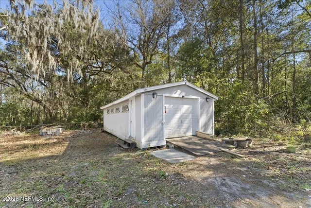 a view of a barn in the middle of a yard