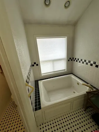a bed sitting in a room next to a window