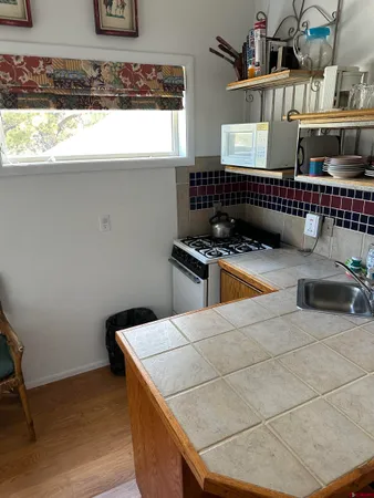 a view of a house with a patio and a yard