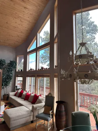 a living room with furniture and a floor to ceiling window