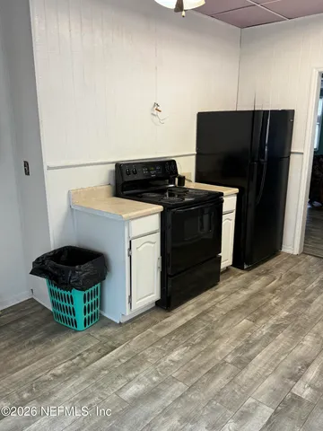 a kitchen with a stove and a refrigerator