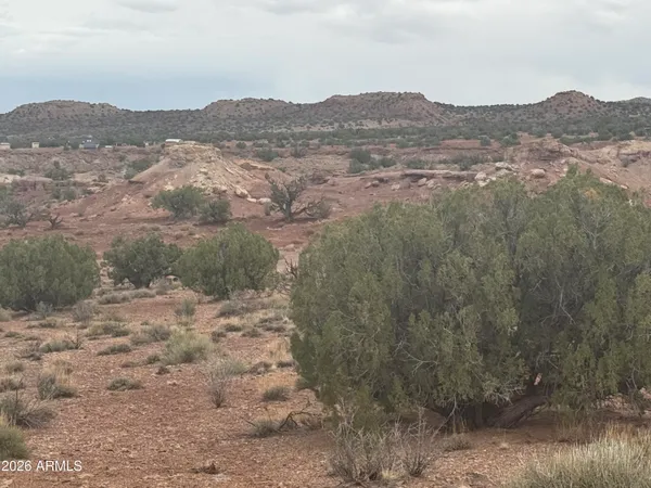 a view of a large mountain with mountains in the background
