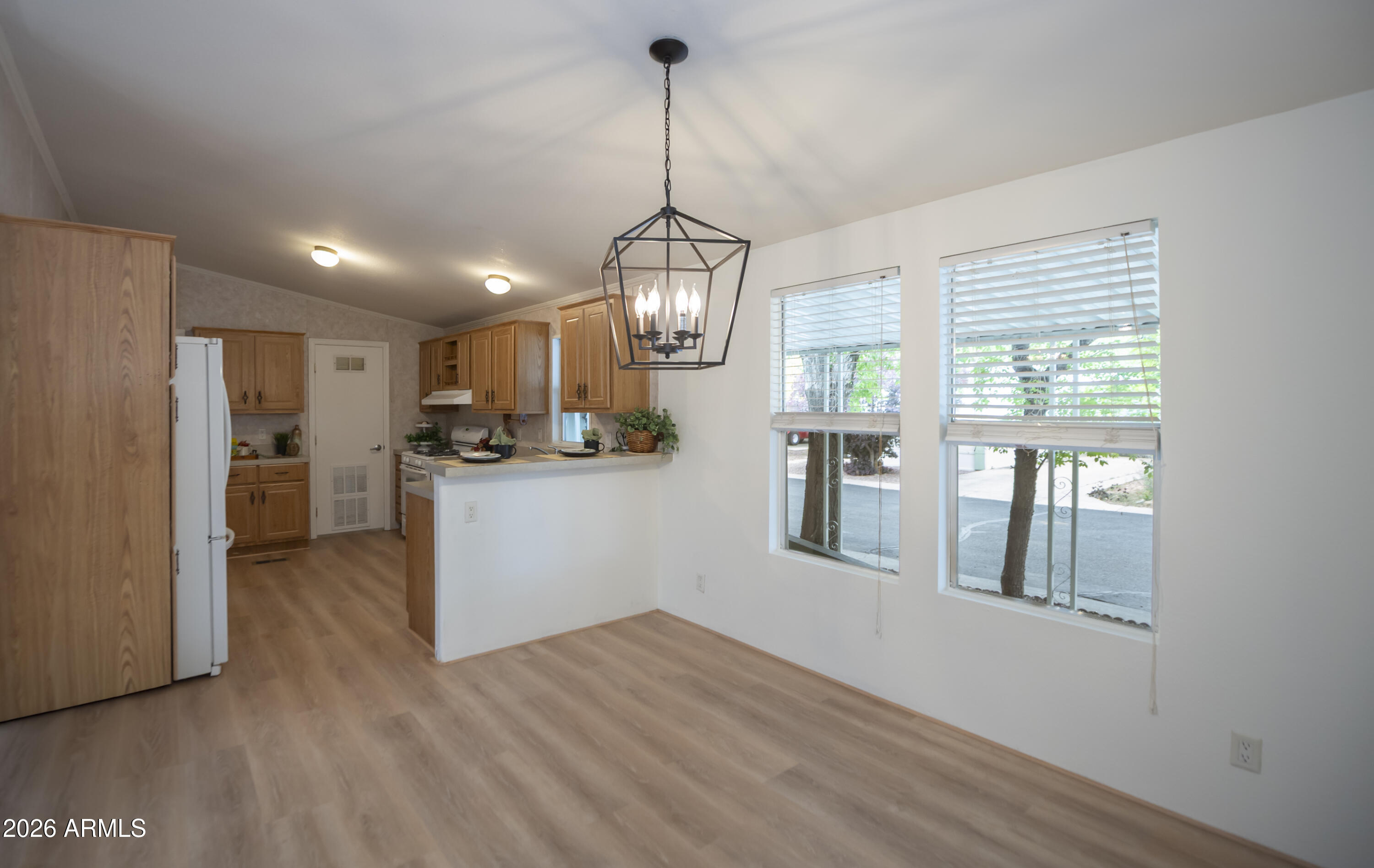 11250 East State Rte 69, Unit 1125 Dewey, AZ 86327 - Photo 11 of 45 a kitchen with stainless steel appliances granite countertop cabinets a refrigerator a sink a stove and a window
