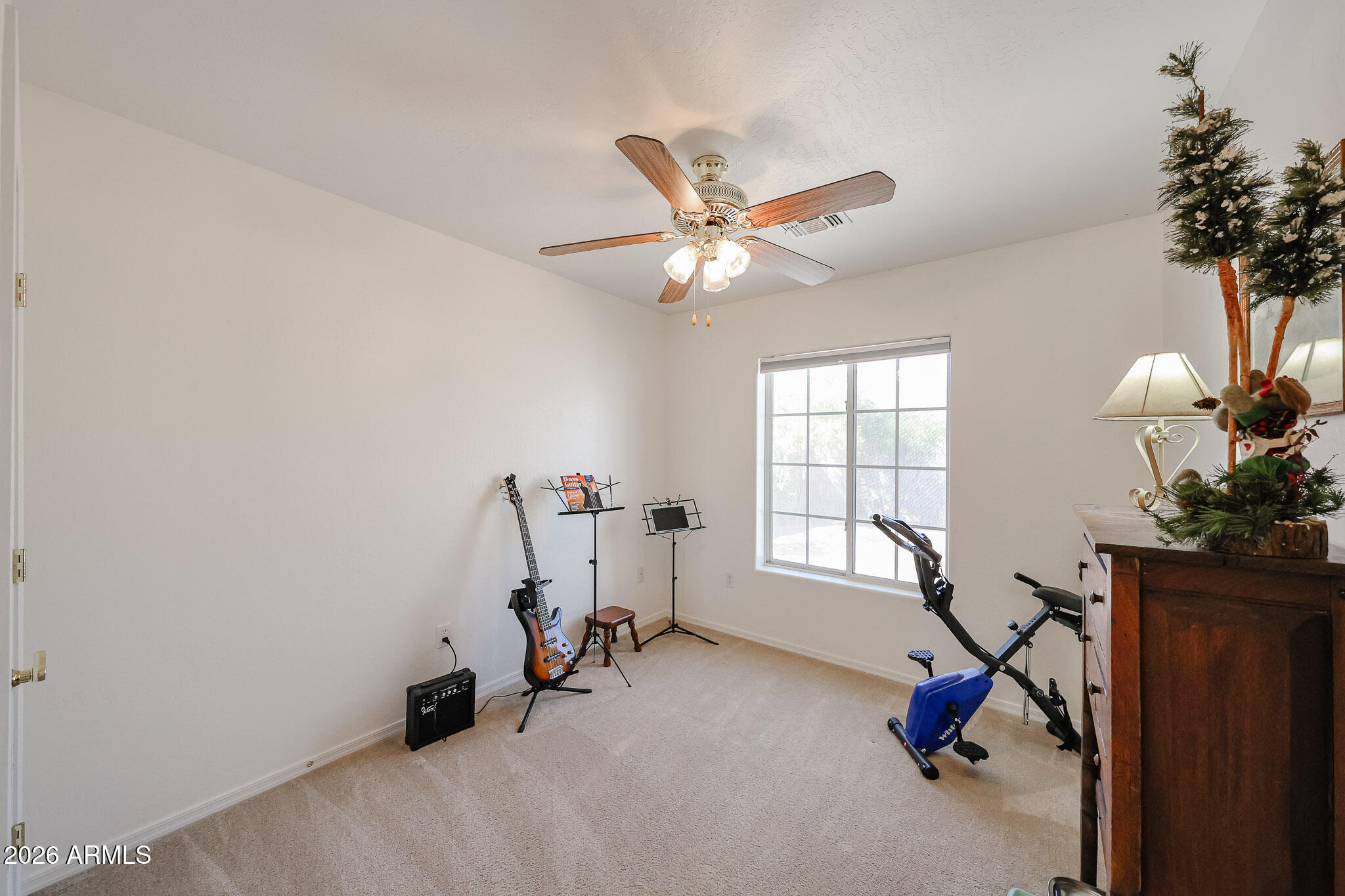 14980 South Capistrano Road Arizona City, AZ 85123 - Photo 19 of 39 a view of a room with gym equipment and a chandelier