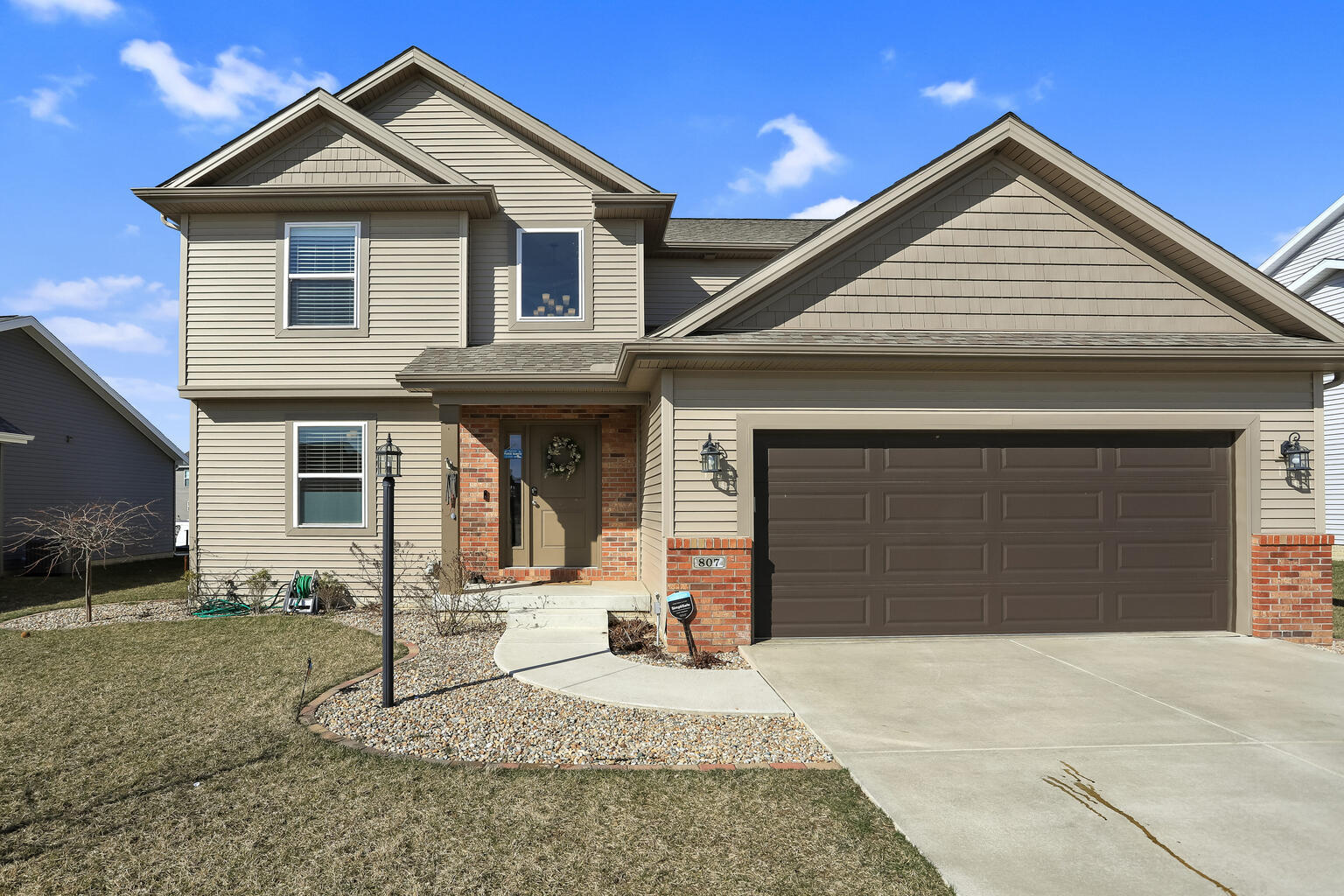 807 Cates Drive Mahomet, IL 61853 - Photo 1 of 33 a front view of a house with a yard and garage