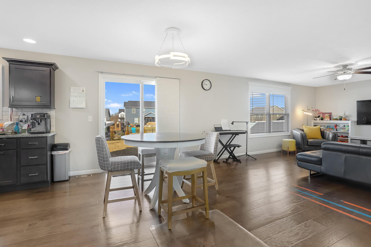 807 Cates Drive Mahomet, IL 61853 - Photo 11 of 33 a living room with furniture and a dining table with kitchen view