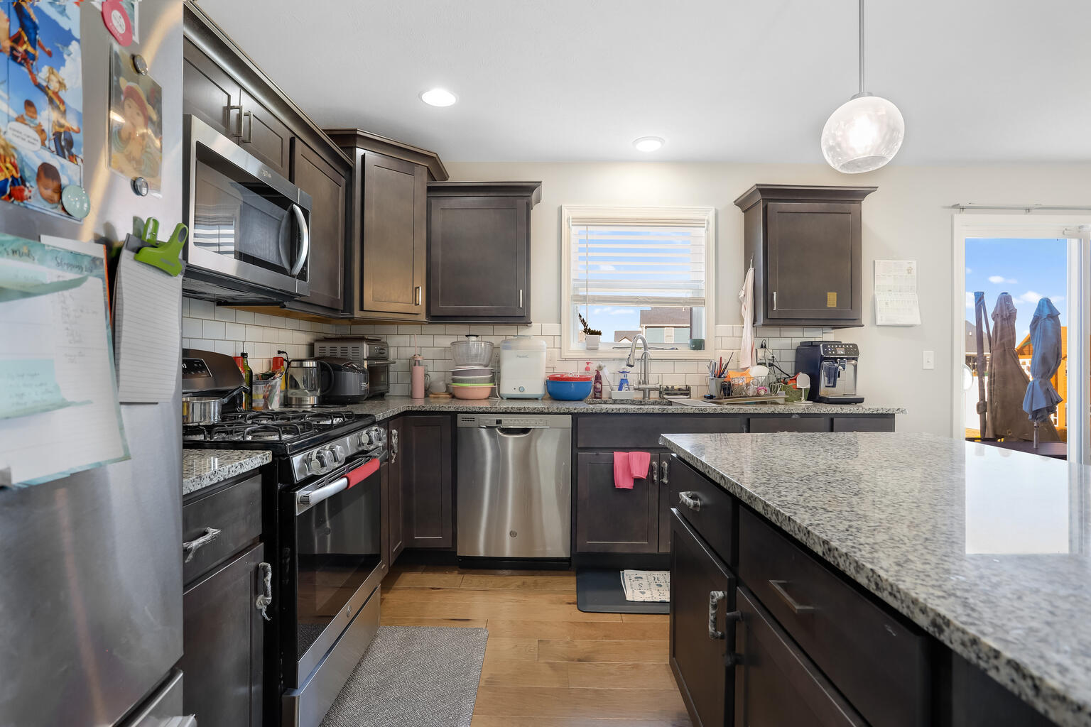 807 Cates Drive Mahomet, IL 61853 - Photo 8 of 33 a kitchen with stainless steel appliances granite countertop a stove top oven a sink and dishwasher